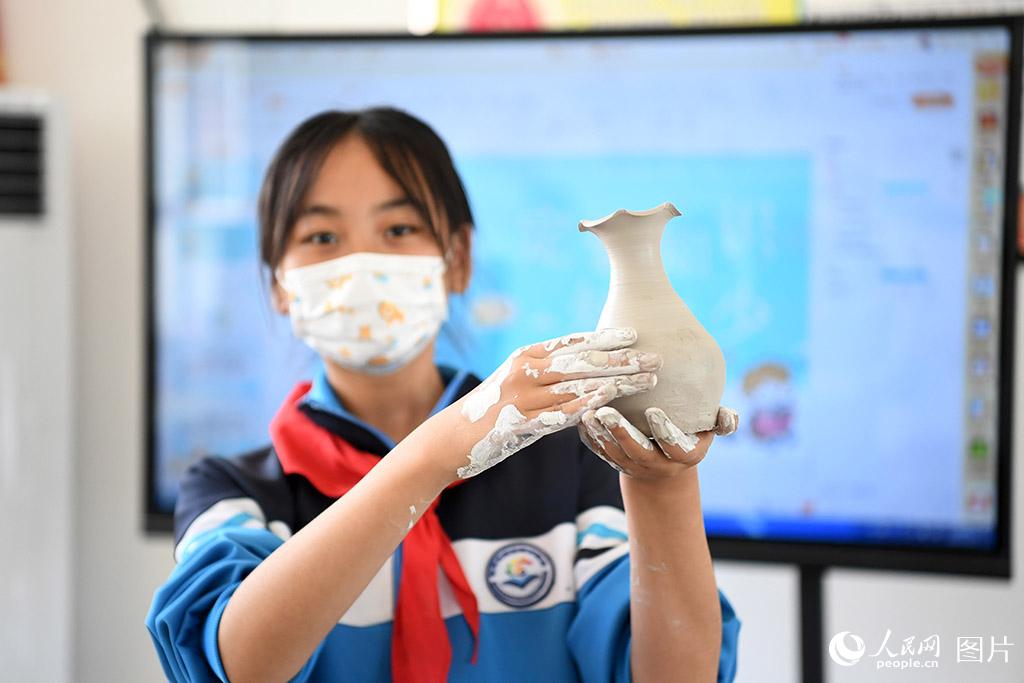 5月31日，河北省定州市清水河小學(xué)學(xué)生展示新制作的定瓷拉坯作品。人民網(wǎng) 周博攝